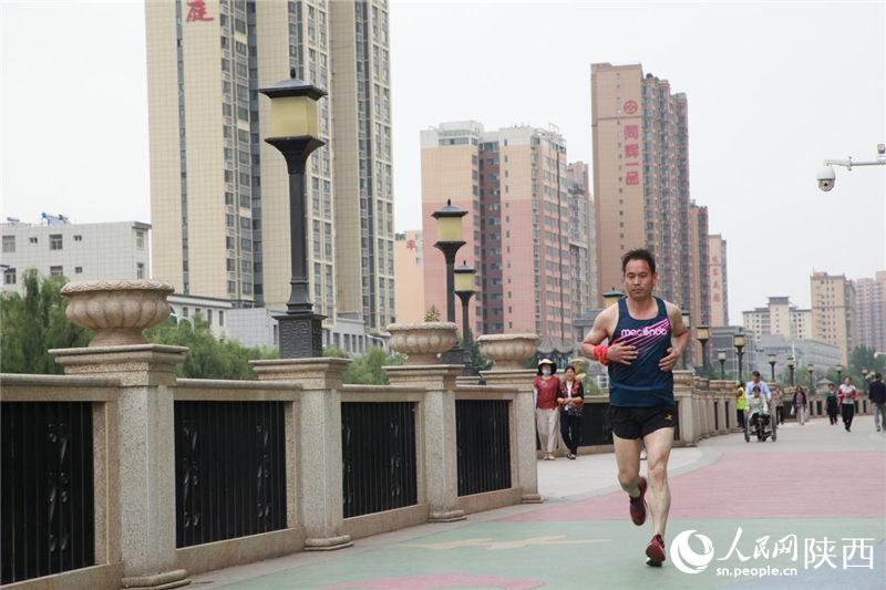 陝西省商洛市山陽縣濱河健身長廊，市民在晨跑。