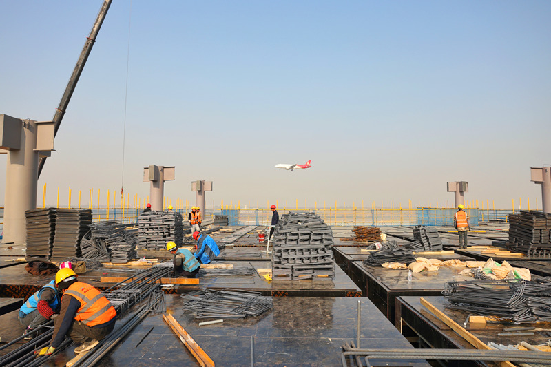 在西安机场三期工程航站楼项目工地现场，建设者们正在加紧施工。 呼延杨帆摄